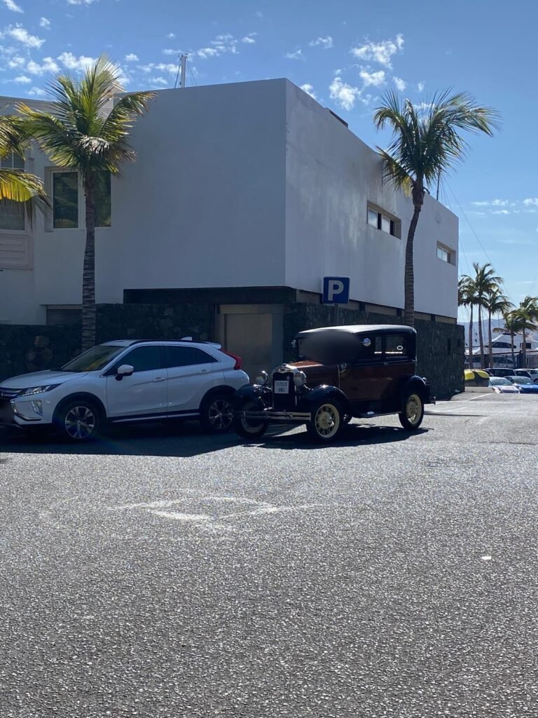 Santi parked beside a white Lanzarote building